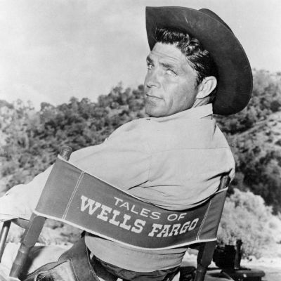 Photo of  Dale Robertson while sitting on a chair.